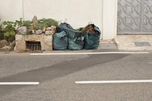 Low-emission van parked on a residential street collecting garden waste