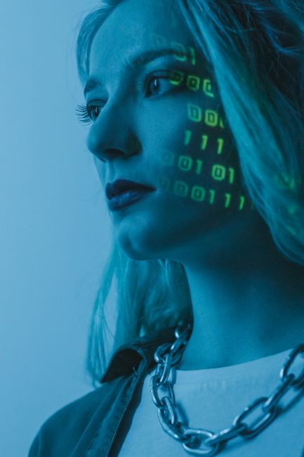 A close-up of a computer screen displaying lines of programming code with syntax highlighting in various colors such as green, orange, white, cyan, and yellow. The code appears to involve functions an